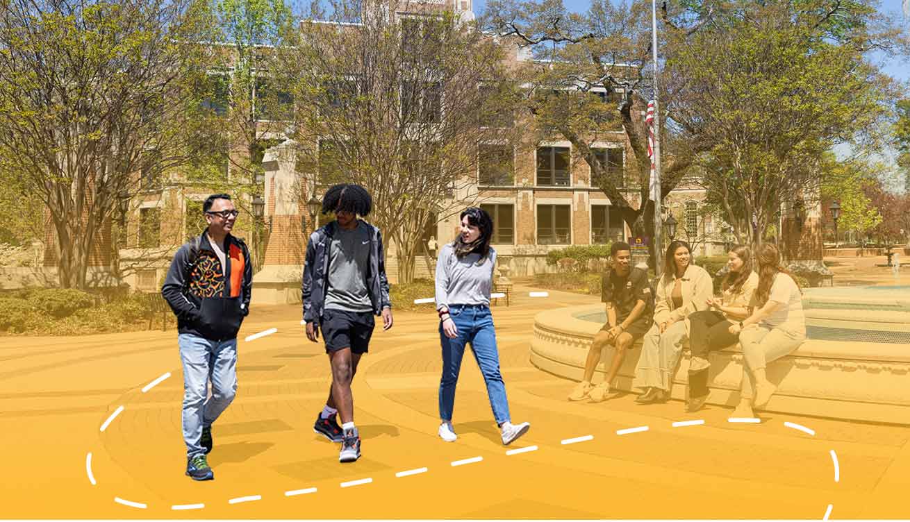 students walking near a large fountain